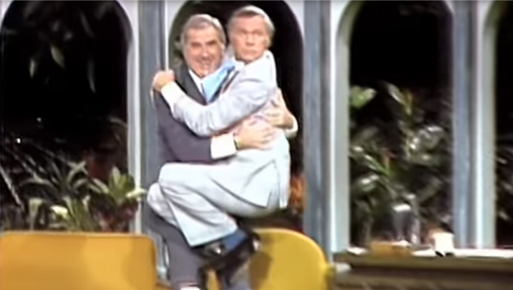 Startled Johnny Carson Takes Flying Leap Into Ed McMahon’s Arms After Cheetah Takes A Swipe
