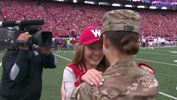 Soldier mom returns to surprise daughter at a Wisconsin football game