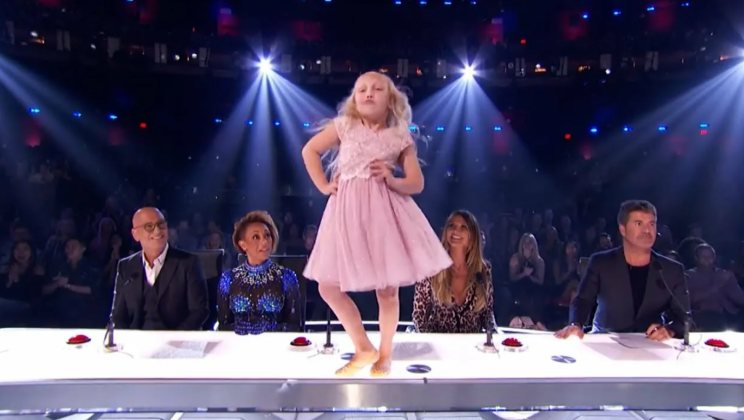 A boy and a girl enter the dance floor under Footloose, circling the judges’ heads