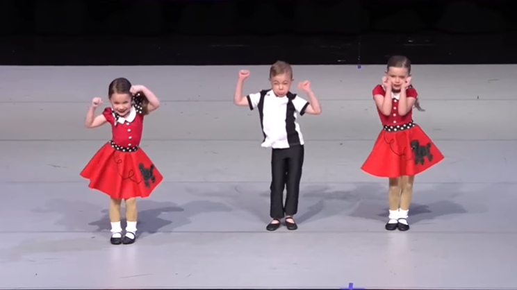 Three little dancers line up, but the middle dancer steals the show.