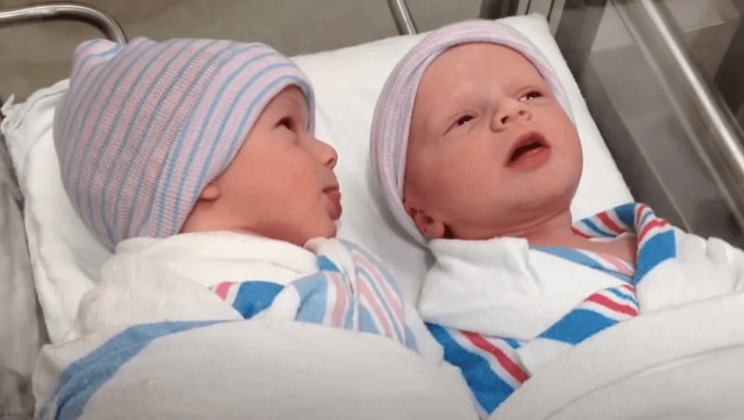 Dad catches his one-hour-old twins chatting cutely with each other