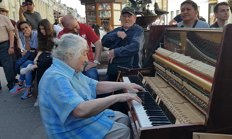 Everyone’s eyes pop as a frail elderly woman begins to play